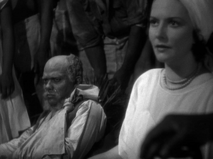 Here's Juanita condemning her husband for his resistance and sentencing him to death-- while the voodoo priest sits in the foreground. Though Juanita has broken free of her family's trans generational domination, she has merely substituted one male master for another, something she'll realize in due time.